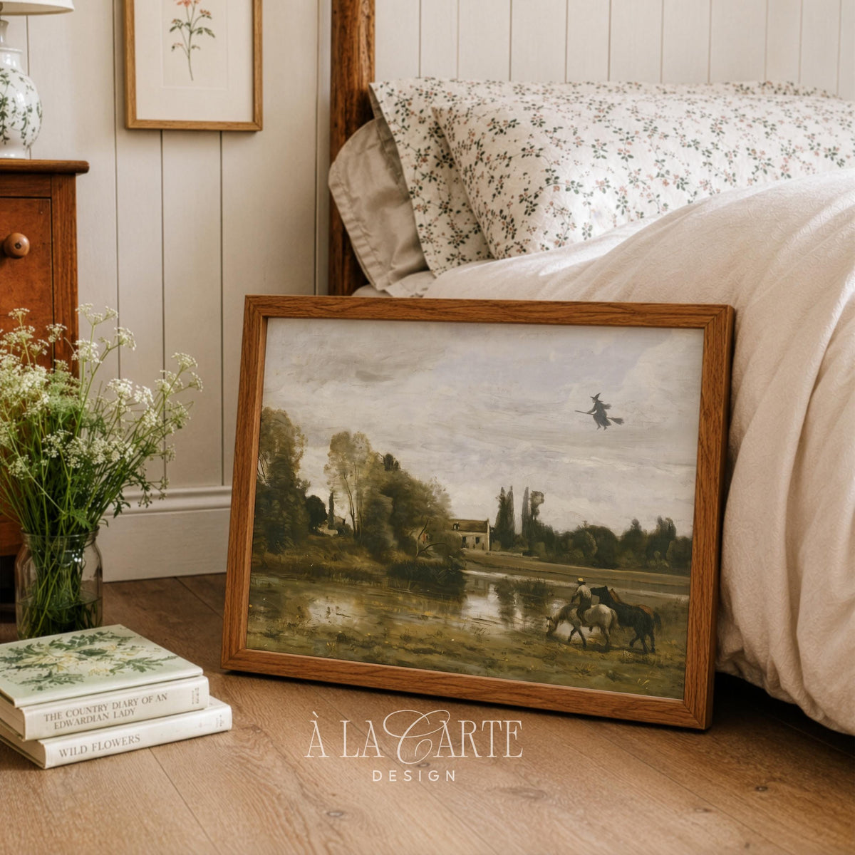 Spooky yet elegant printable art for gallery wall — witch overhead above calm pastoral scene with muted palette