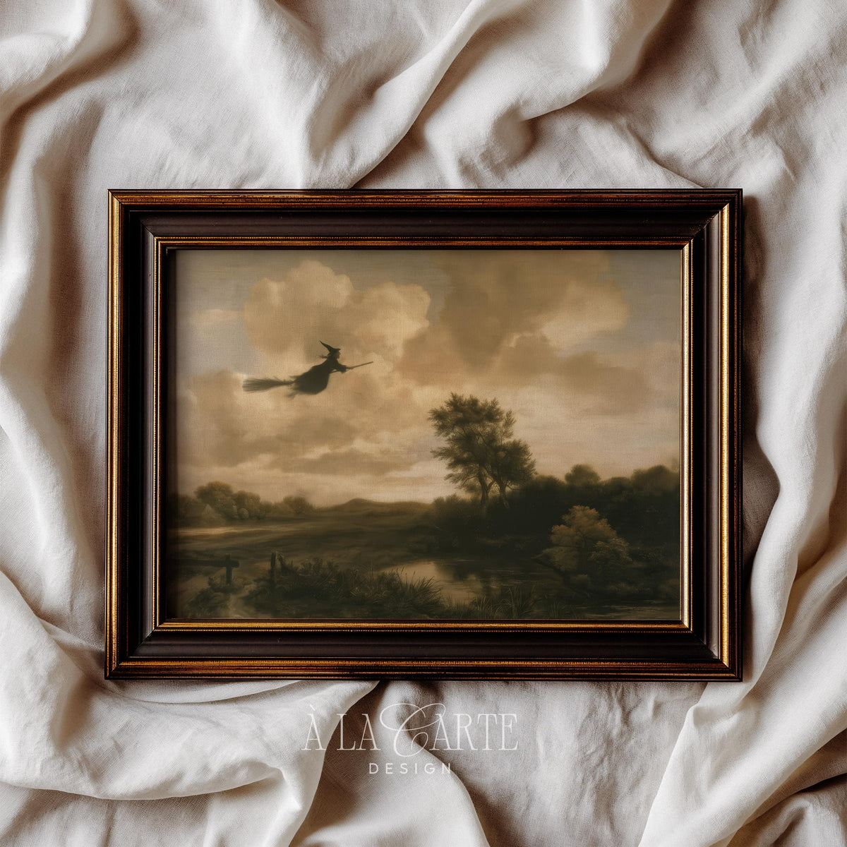 Gothic vintage art print for hallway — witch crossing stormy skies above quiet rural terrain