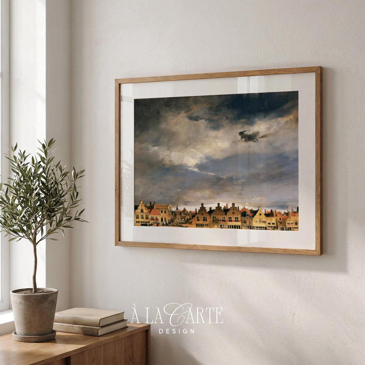 Flying enchantress poster for entryway — storybook Halloween scene with layered cloudy sky and historic roofline