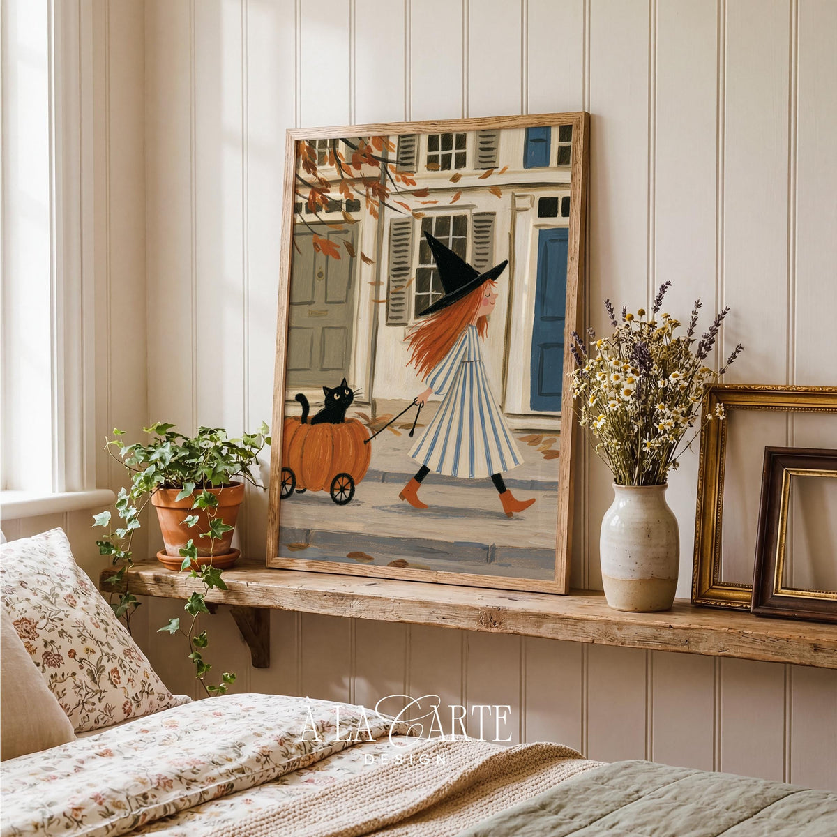 Folksy seasonal artwork for nursery — soft-hued witch tale with peaceful village backdrop and falling leaves