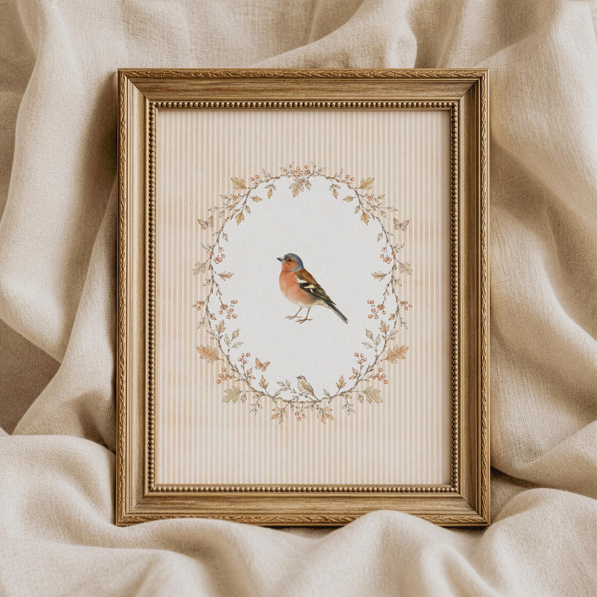 Cottage-core finch printable wall art — muted gold leaf wreath surrounding small perched bird on vintage background